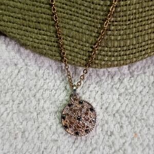 Goldtone black crystals round pendant necklace